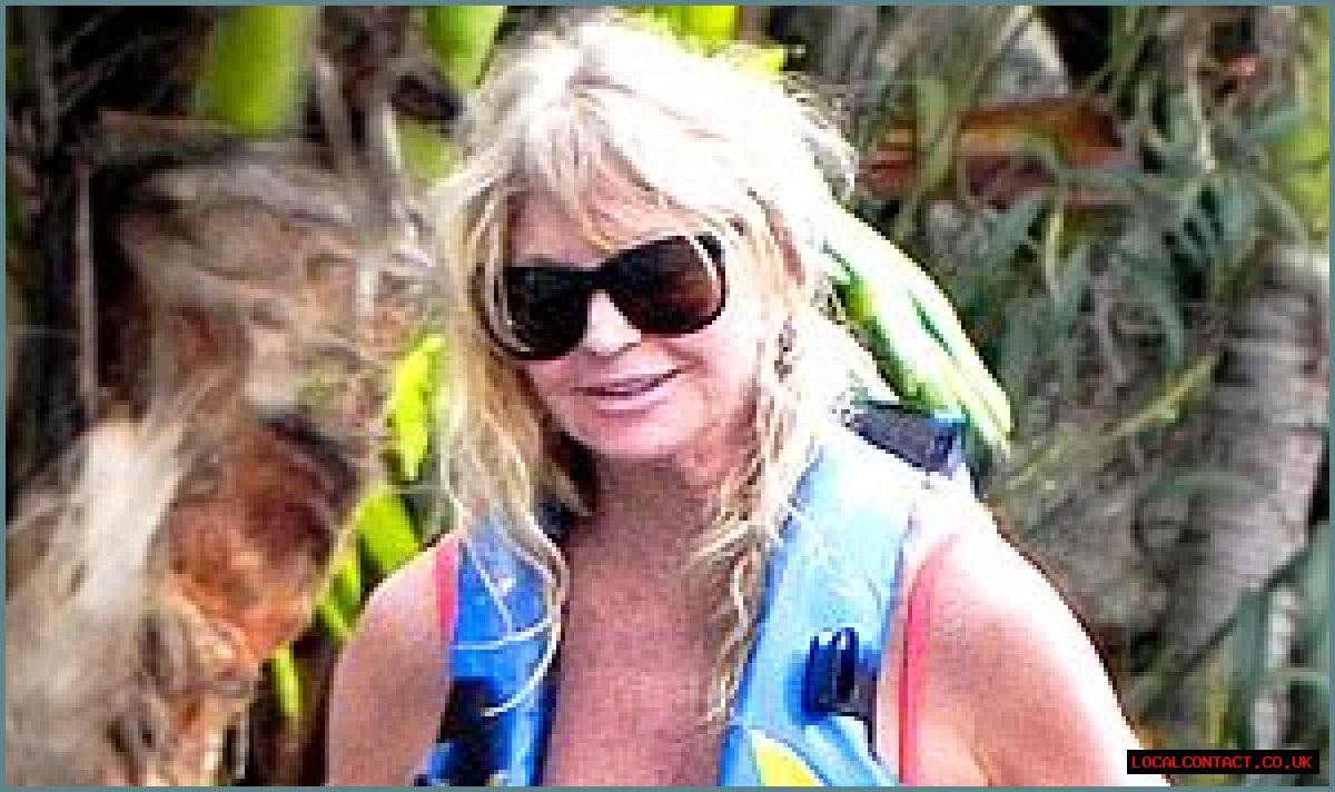 Goldie Hawn Rocks a Red Swimsuit at Age 67, Feeds Dolphins With Kurt Russell